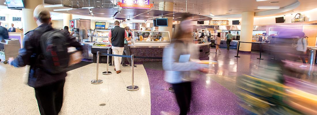 Busy students create a blur making their way through Market Square, the main TCU campus dining hall. 